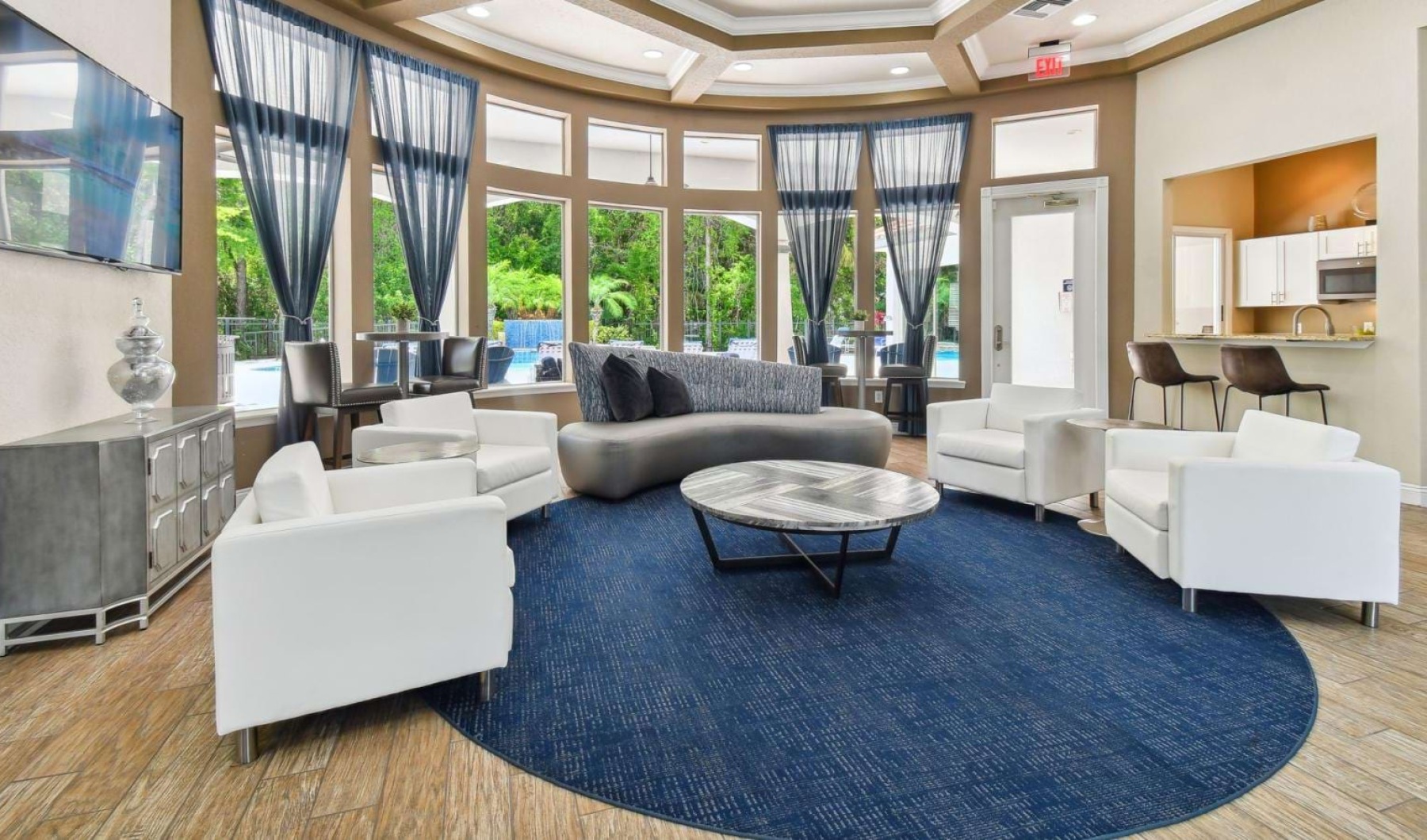a living room with a large blue rug and a white couch