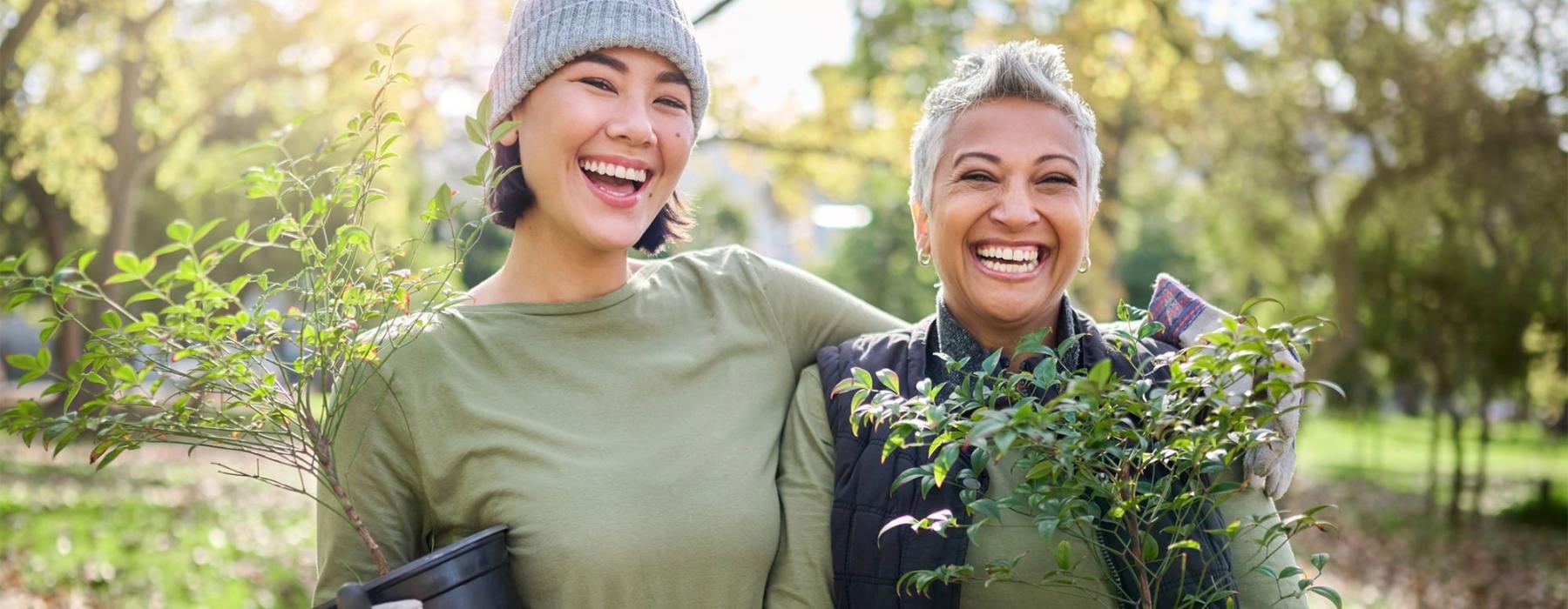 a couple of women holding plants